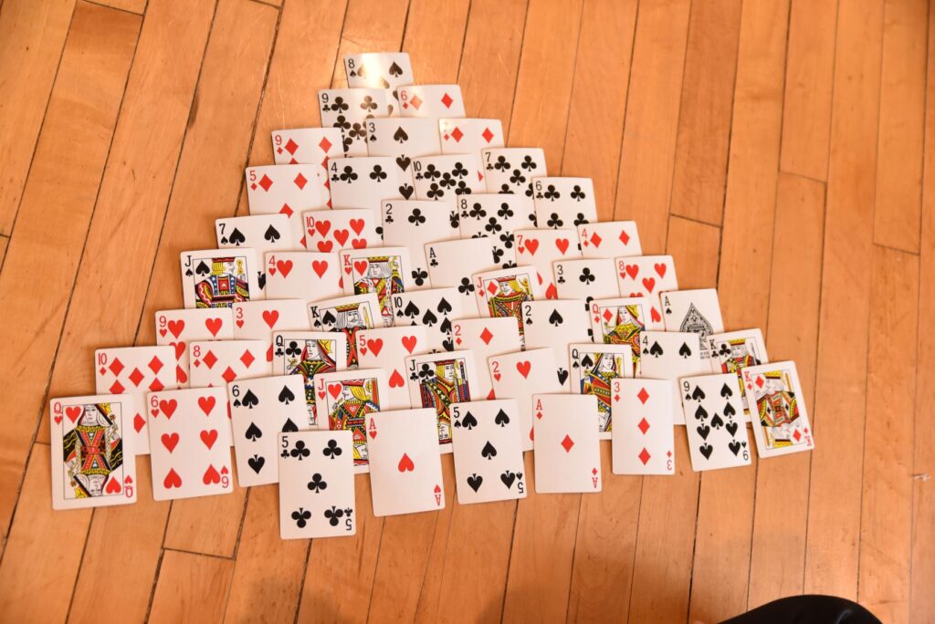 Playing cards set up to play Pyramid Solitaire.