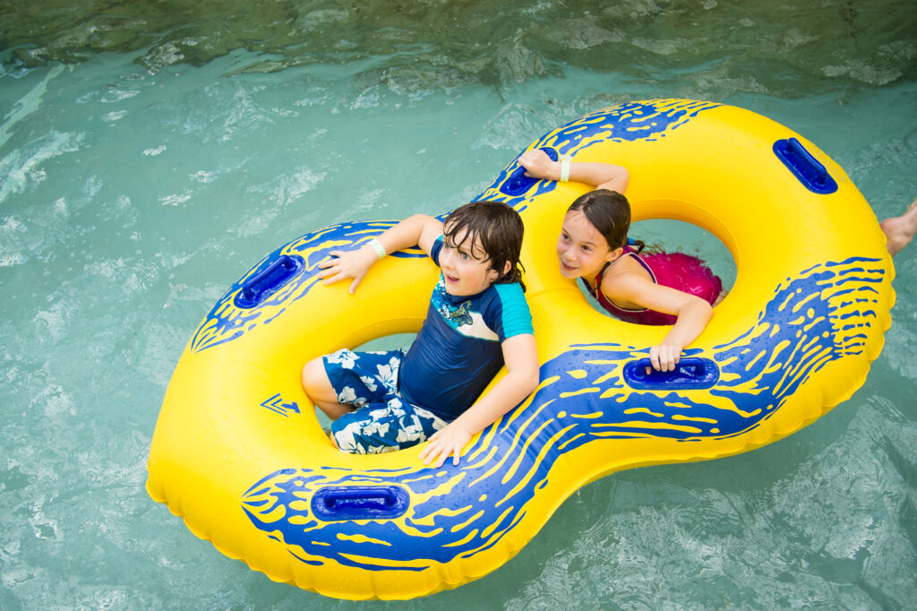 Kids floating in a tube at a waterpark.