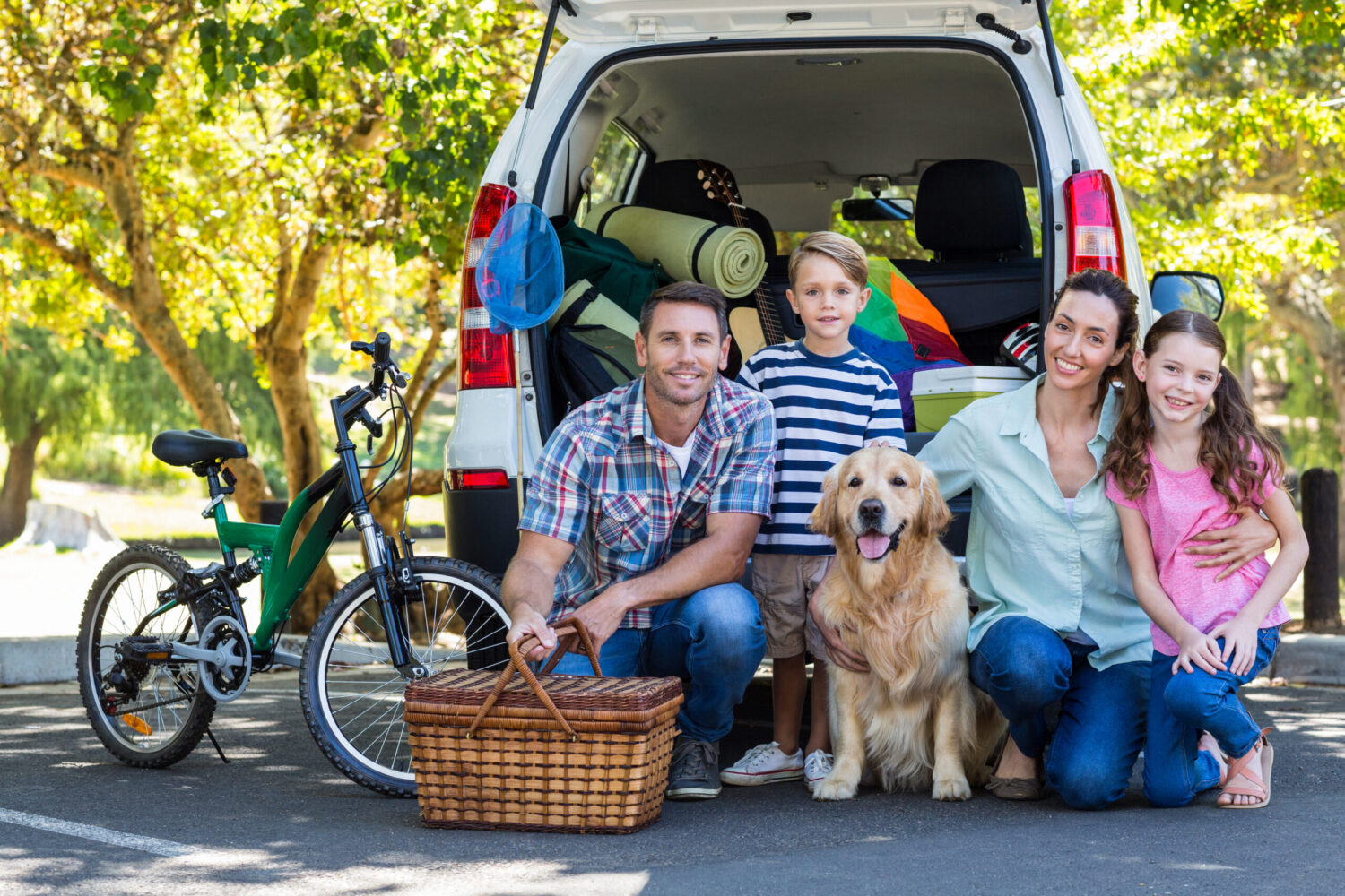 Happy family getting ready for a fun summer road trip.